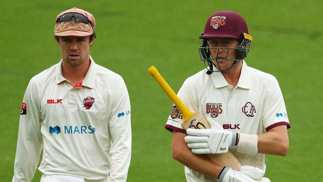 SA captain Travis Head leaves the field with Marnus Labuschagne after he hit Queensland to victory. Picture: Chris Hyde/Getty Images