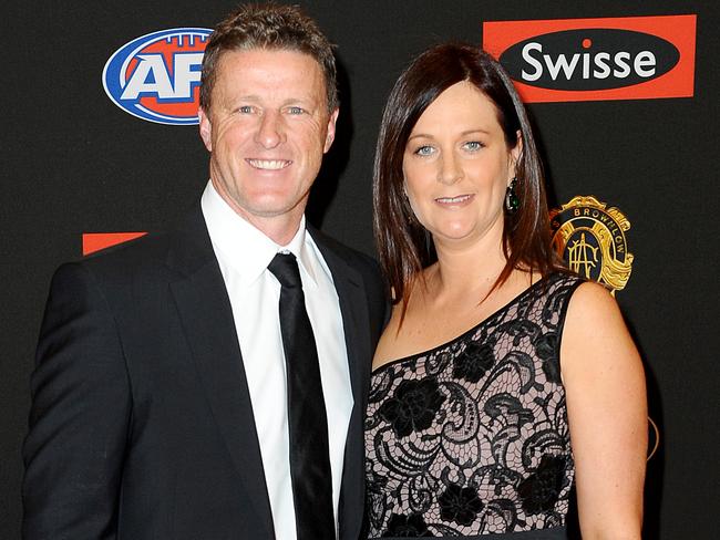 Richmond coach Damien Hardwick and wife Danielle pose for photos on the red carpet at the Brownlow Medal awards in Melbourne, Monday, Sept. 22, 2014. The Brownlow Medal is the AFL's best and fairest award. (AAP Image/Joe Castro) NO ARCHIVING