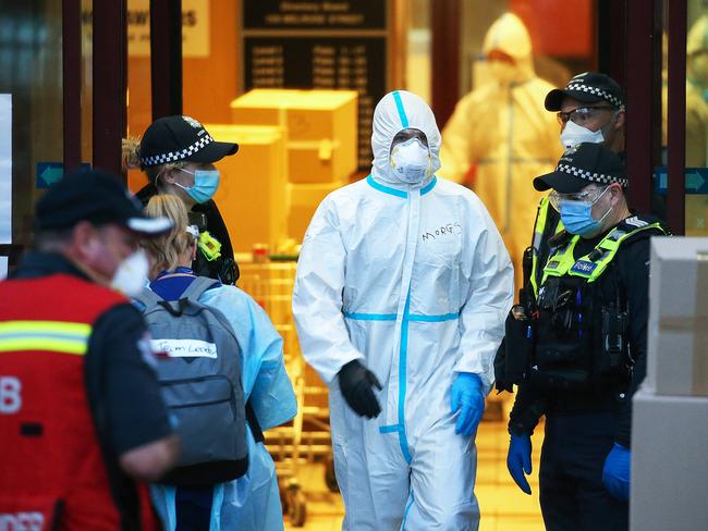 Police and health workers outside the North Melbourne towers. Picture: Ian Currie