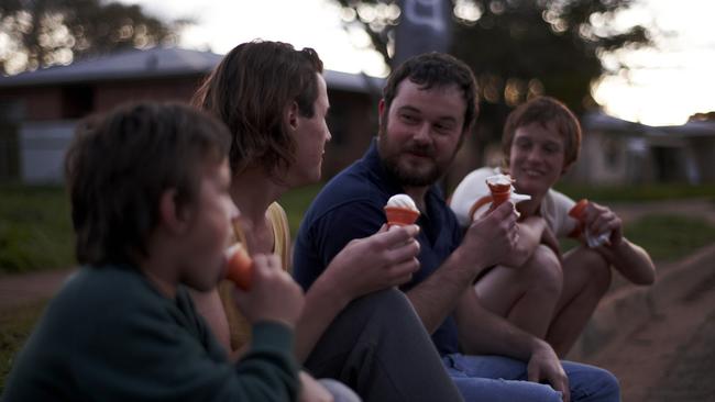 Actors Lucas Pittaway as Jamie Vlassakis (second from left) and Daniel Henshall as John Bunting (second from right) in a scene from the 2011 film Snowtown.