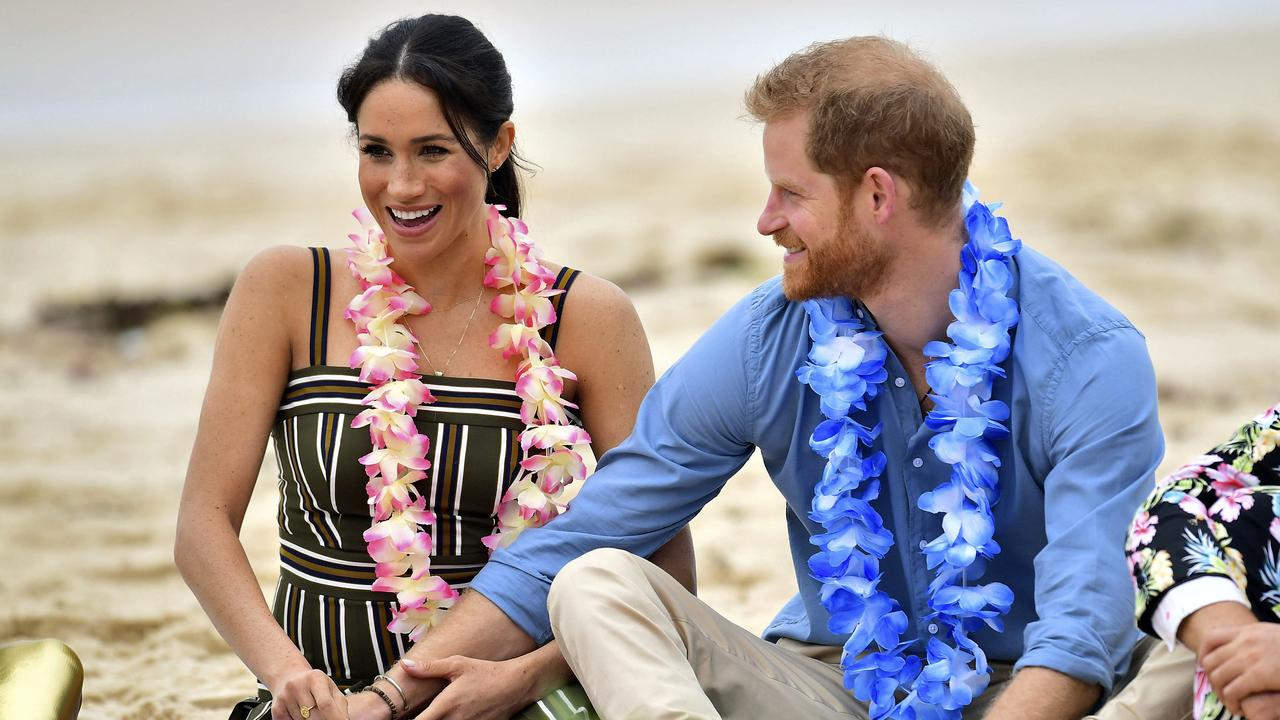 Britain's Prince Harry and Meghan, Duchess of Sussex meet a local surfing community group, known as OneWave, raising awareness for mental health and wellbeing in a fun and engaging way at Bondi Beach Sydney, Australia, Friday, Oct. 19, 2018. Prince Harry and his wife Meghan are on day four of their 16-day tour of Australia and the South Pacific. (Dominic Lipinski/Pool via AP)