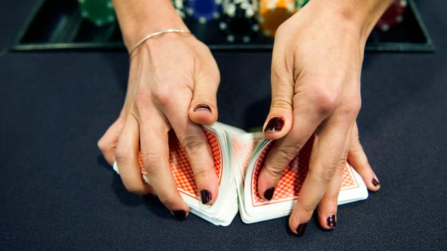 Two men have succeeded in having a ban by Star Entertainment overturned, after they were accused of “edge sorting” or spotting irregularities on the back of cards to gain an advantage. Picture: Lionel Bonaventure/AFP