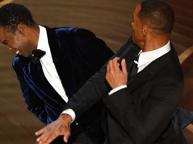 (FILES) In this file photo taken on March 27, 2022 US actor Will Smith (R) slaps US actor Chris Rock onstage during the 94th Oscars at the Dolby Theatre in Hollywood, California. - Chris Rock finally hit back at Will Smith on March 4, 2023 in a brutal stand-up routine, a year after the actor slapped him in front of a global TV audience for the Oscars. (Photo by Robyn Beck / AFP)