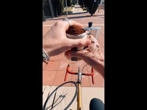 Multitasking barista creates coffee on the go while riding bike