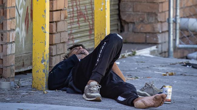 A man openly injects drugs into his leg in a thoroughfare alley a few hundred meters from the Richmond Safe Injecting Room. Picture: Jason Edwards