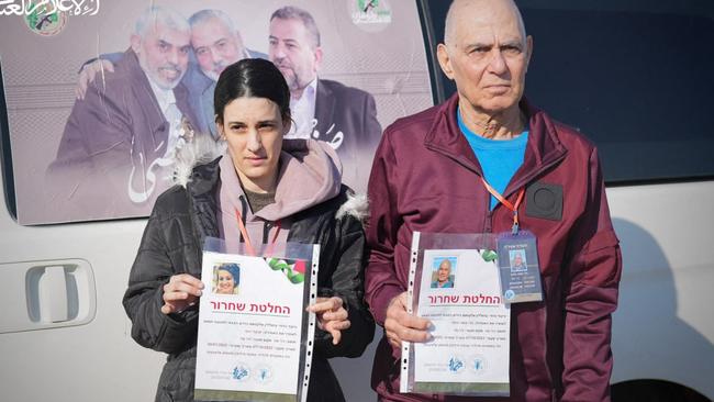 Israeli-German nationals Gadi Moses, 80, and Arbel Yehud, 29 hold Hamas ‘certificates’ during their handover to a Red Cross team in Khan Yunis. Picture: AFP.