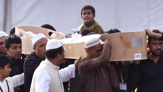 A child looks on as mourners carry the coffin of one of Brenton Tarrant’s victims. Picture: AP