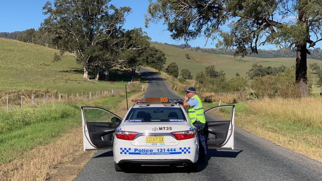 Police search for the shooter at Bingleburra near Dungog. Pictures: Peter Lorimer 