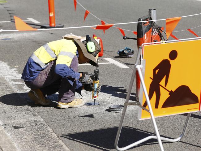 A  Hobart City Council worker installing sensors in the Montpelier Retreat to detect when a car has overstayed its welcome. Picture: MATT THOMPSON