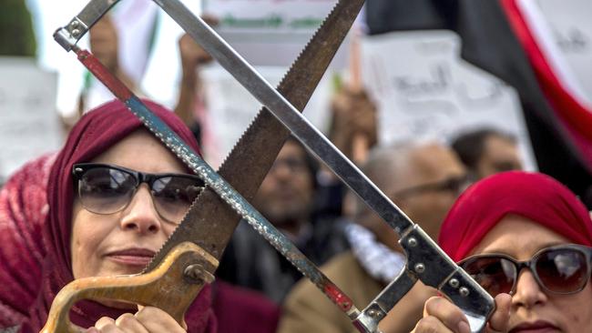 Tunisians demonstrate with saws in Tunis amid international concern about the killing of Jamal Khashoggi. Picture: Hassene Dridi