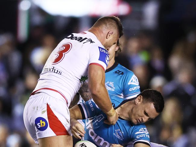 SYDNEY, AUSTRALIA - AUGUST 06:  Connor Tracey of the Sharks is hit high in a tackle by Tariq Sims of the Dragons during the round 21 NRL match between the Cronulla Sharks and the St George Illawarra Dragons at PointsBet Stadium, on August 06, 2022, in Sydney, Australia. (Photo by Matt King/Getty Images)