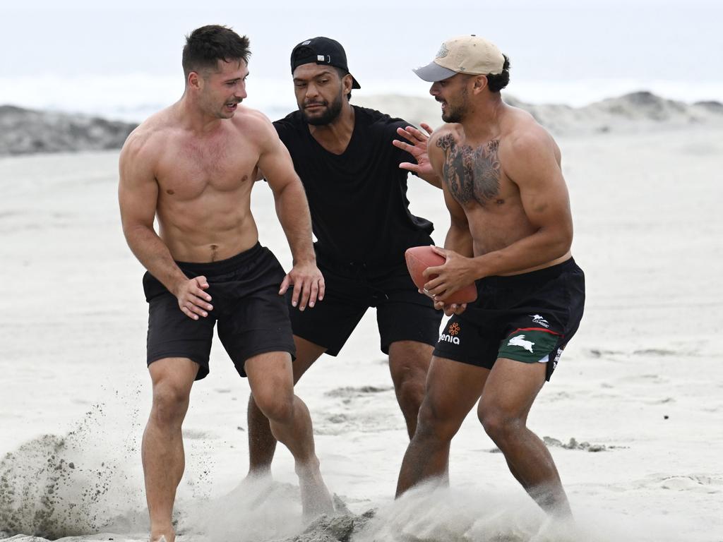 Lachlan Ilias and Rabbitohs teammates Taane Milne, and Isaiah Tass play American football on Coronado City Beach. Picture: Getty Images