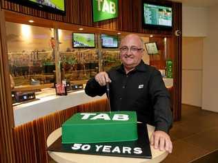 Glenn Munsie cuts the cake for the TAB's 50th. Picture: Stephen Cooper