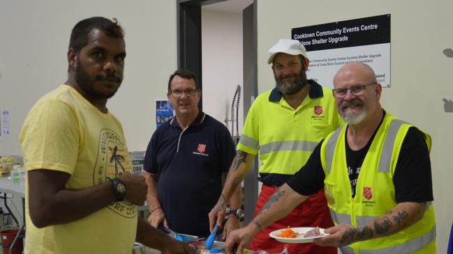 Wujal Wujal resident Frederick Darkan grabs a ham and salad meal from Salvation Army Emergency Services North Queensland co-ordinator Lincoln Stevens, and volunteers Mark Johns and Greg Colby. Picture: Bronwyn Farr