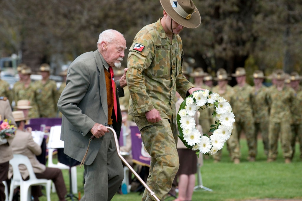 Milne Bay veteran Bert Miles is escorted by CPL Owen Bambrick of 25/49 RQR to lay a wreath at the 69th anniversary of the Battle of Milne Bay and the Mothers' Memorial, Toowoomba, Sunday, August 28, 2011. Photo Kevin Farmer / The Chronicle. Picture: Kevin Farmer