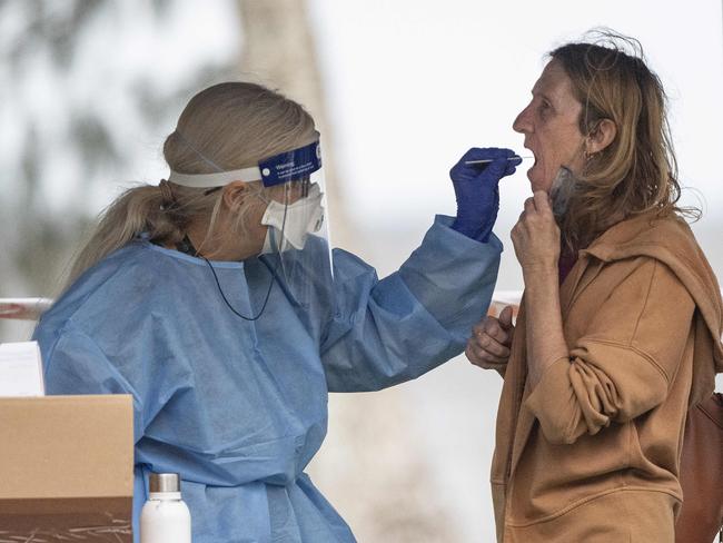 A woman takes a covid test at the testing facility on the Esplanade. Picture : Brian Cassey