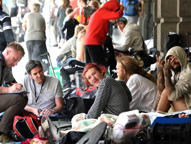 Social service officers offer help to rough sleepers outside Flinders street station. Picture: Nicole Garmston