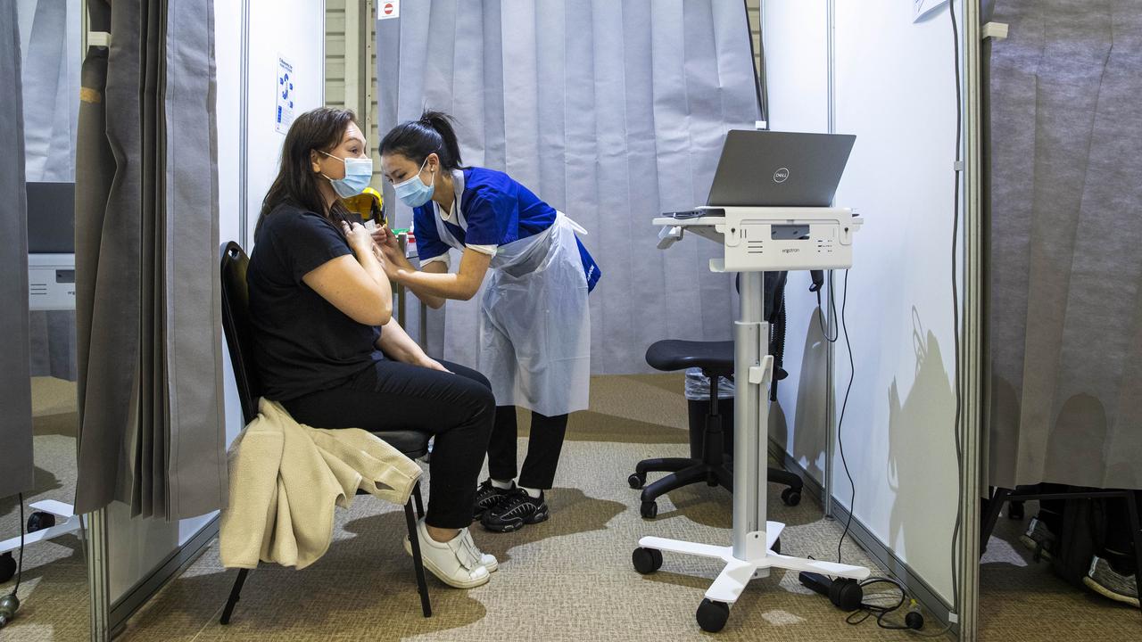 Anniina Pitkaenen is vaccinated by Western Health staff at a Covid-19 mass vaccination centre at the Melbourne Showgrounds. Picture: Aaron Francis/The Australian