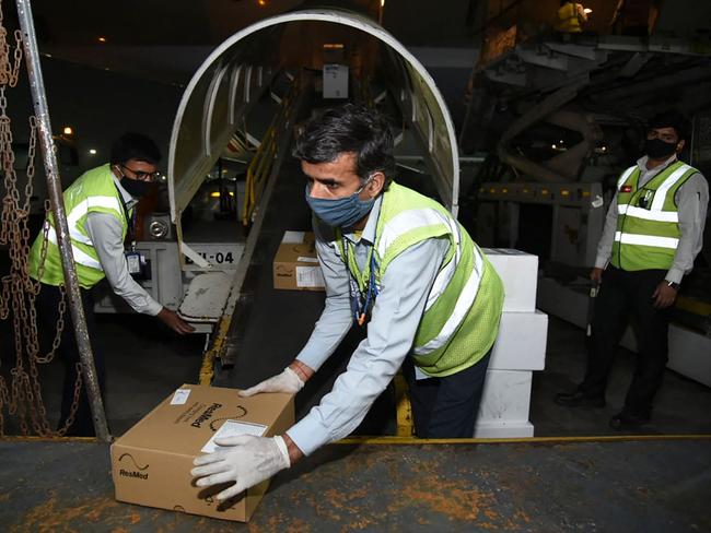 Ground staff unloading medical aid from an aircart sent from the UK upon its arrival in New Delhi. Picture: Foreign, Commonwealth &amp; Development Office / AFP