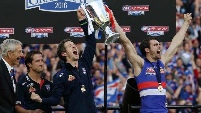 Bob Murphy lifts the premiership cup with Easton Wood. Picture: Wayne Ludbey