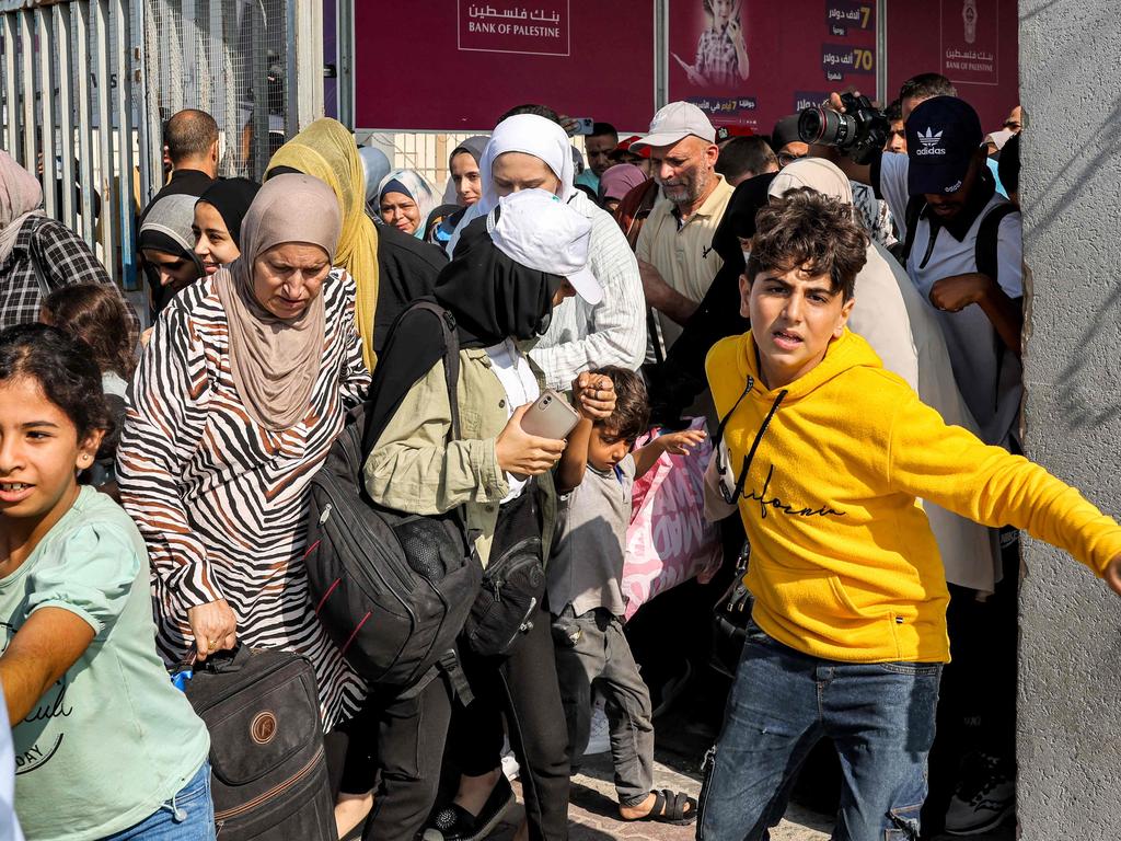 People walk through a gate to enter the Rafah border crossing to Egypt in the southern Gaza Strip. Picture: AFP