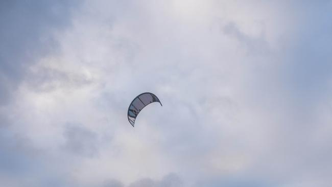 A kitesurfer sustained laceration injuries after a gust of wind lifted him off the surf of Ettalong Beach and into nearby powerlines.Picture: NewsWire/Flavio Brancaleone