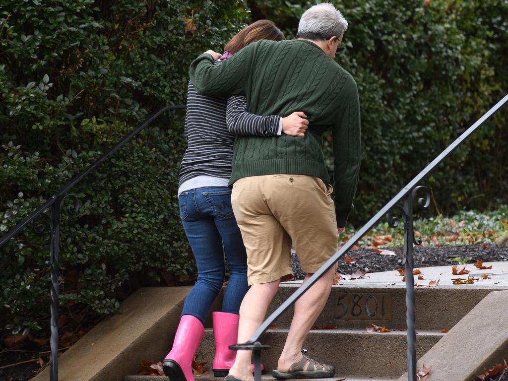 Neighbours around the corner from the site of a mass shooting at the Tree of Life Synagogue embrace one another in the Squirrel Hill neighbourhood in Pittsburgh, Pennsylvania. Picture: Getty