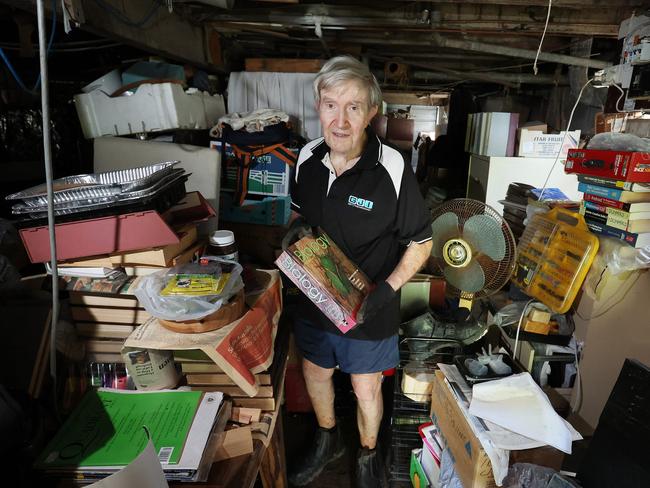 Selwyn Russell with his flooded possessions. Picture: Liam Kidston.