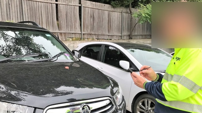 A Northern Beaches Council enforcement ranger checking parked cars. The council now has a ticketless parking fine system. Picture: Northern Beaches Council