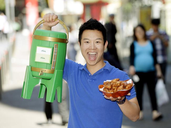 James Sun from Arisun restaurant in Dixon Street , Sydney holding a 4.5 litre jug of beer and a bowl of Soy fried chicken.