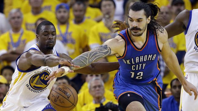 Oklahoma City Thunder's Steven Adams (12) fights for a loose ball against Golden State Warriors' Harrison Barnes (40).