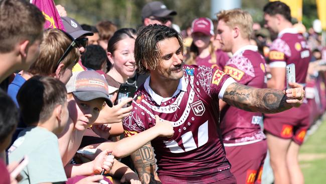 Jesse Arthars takes a selfie with Queensland fans. Picture Lachie Millard