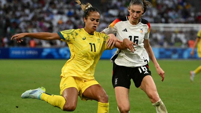 Australia's forward #11 Mary Fowler is marked by Germany's midfielder #16 Jule Brand during the women's group B football match between Germany and Australia during the Paris 2024 Olympic Games at the Marseille Stadium in Marseille on July 25, 2024. (Photo by Christophe SIMON / AFP)