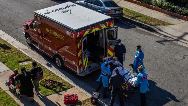 County of Los Angeles paramedics load a potential COVID-19 patient into an ambulance. Picture: Picture: Apu Gomes/AFP