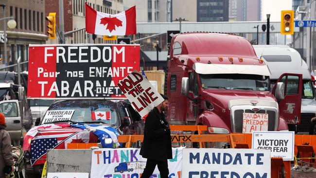 A protester walks in front of parked trucks as demonstrators protest the vaccine mandates implemented by Prime Minister Justin Trudeau in February, 2022. Picture: Dave Chan/AFP