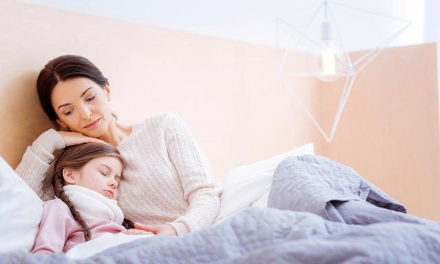 Support. Caring loving kind mother hugging her cute little ill sleeping daughter