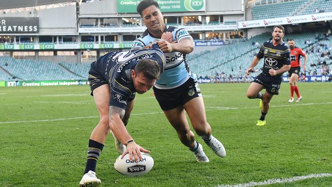 Kyle Feldt gets the Cowboys away with their first try.