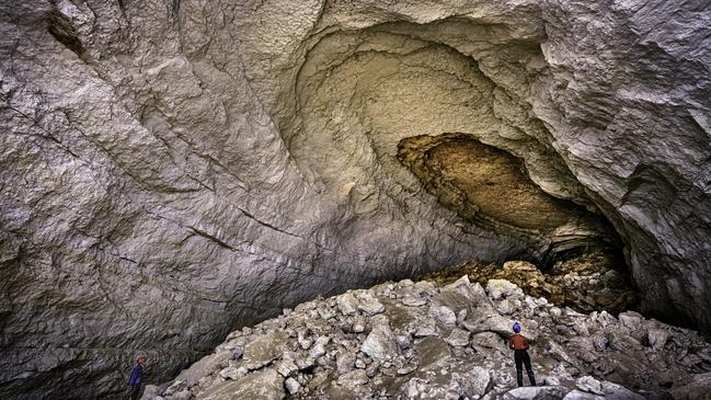 This large Nullarbor cave passage was formed by gradual upwards collapse of the roof over millions of years. Deeper beneath the rock-strewn floor lies the aquifer and a large waterfilled conduit, which has been gradually dissolving the soluble carbonate limestone and carrying it away, enabling the cave to grow larger over time. Picture: Stefan and Bronwen Eberhard