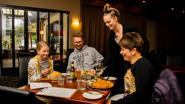 Ophelia, Brett Coshell, and Aldona Pretty are served by Amy Dreckowat the Kensington Hotel. Picture: The Advertiser, Morgan Sette