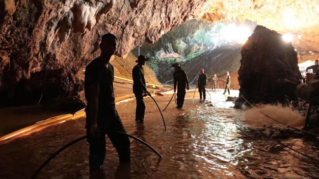 In this undated photo released by Royal Thai Navy on Saturday, July 7, 2018, Thai rescue teams arrange water pumping system at the entrance to a flooded cave complex where 12 boys and their soccer coach have been trapped since June 23, in Mae Sai, Chiang Rai province, northern Thailand. The local governor in charge of the mission to rescue them said Saturday that cooperating weather and falling water levels over the last few days had created appropriate conditions for evacuation, but that they won't last if it rains again.. (Royal Thai Navy via AP)