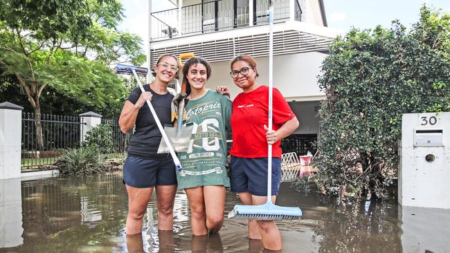 Kesena Brady, Seoro Brady and Vonu Libitino in front of their flooded Elizabeth Street home in Paddington on March 1, 2022. Picture: Zak Simmonds.