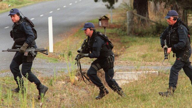 Special Operations police run for cover at the shooting scene near historic Port Arthur in Tasmania in 1996.