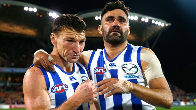 Lindsay Thomas hugs teammate Brent Harvey after his final match for the club during the 2016 elimination final against Adelaide. Picture: Adam Trafford/AFL Media/Getty Images