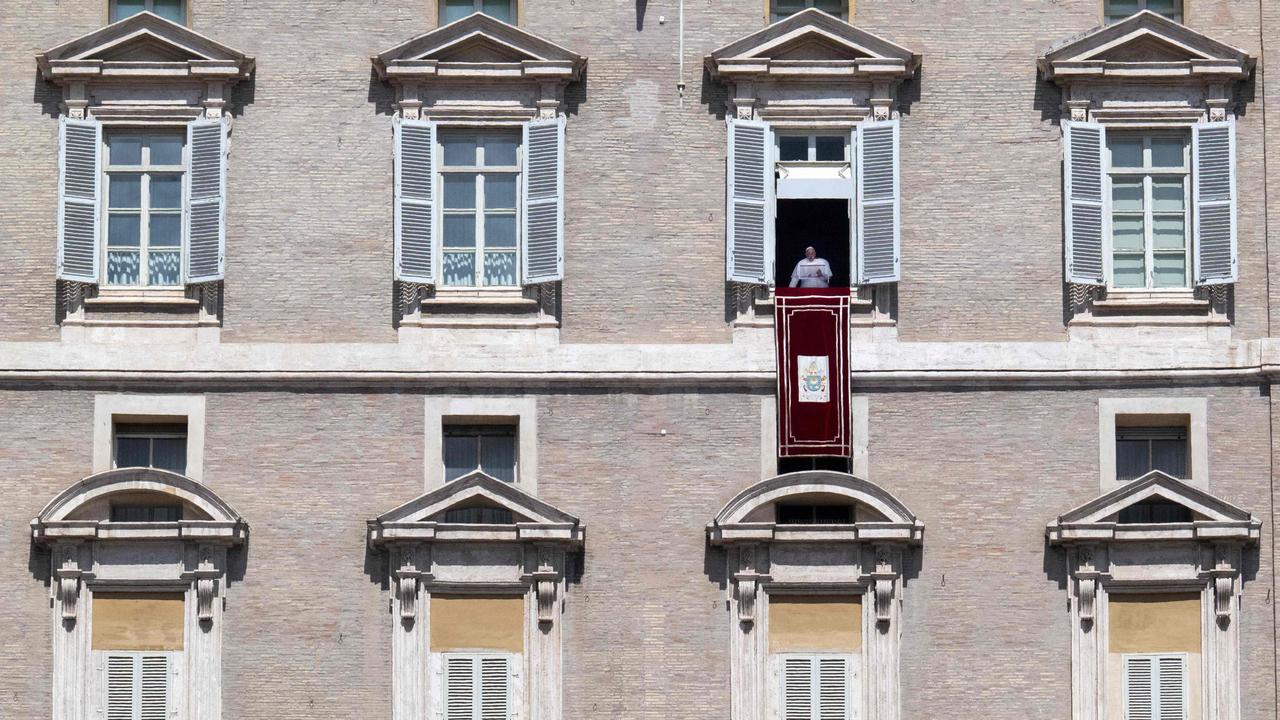 Pope Francis speaks from the window of the apostolic palace overlooking St. Peter's square this month.