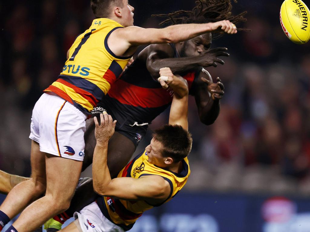 Tom Doedee (bottom) gets flattened in a brutal contest during Adelaide’s round 17 match with Essendon. Pic: Michael Klein