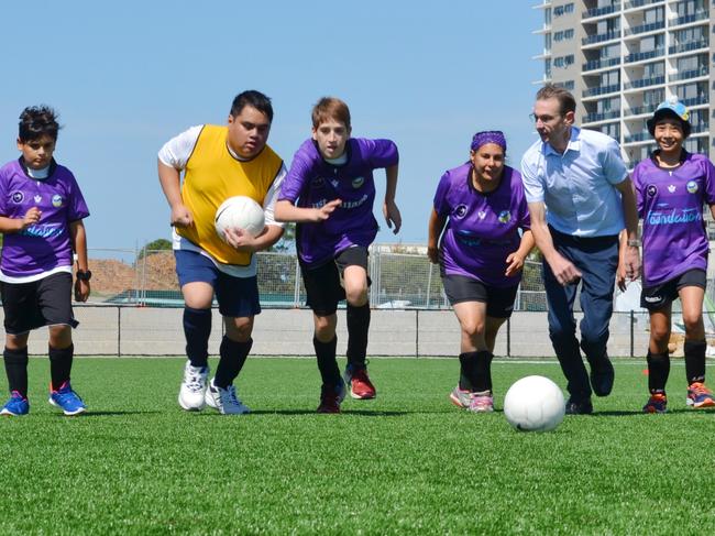 Randwick City Football Club's Purple Hearts players with Coogee Liberal MP Bruce Notley-Smith at their annual gala day at Heffron Synthetic Field on March 12, 2017. The club has received NSW Government funding enabling it to expand the program to 60 enable 60 children and adults with a disability to learn and play soccer, promoting friendship and team spirit. Picture: supplied.