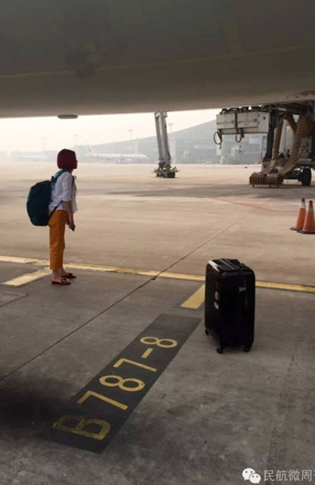 Woman blocks plane on runway. Picture: WeChat