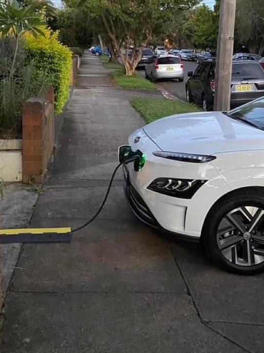 Some electric vehicle owners use extension leads running across footpaths.