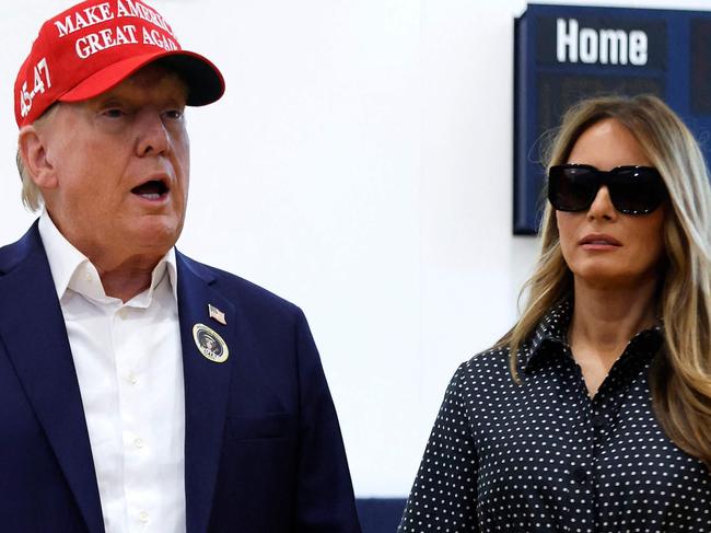 PALM BEACH, FLORIDA - NOVEMBER 05: Republican presidential nominee former President Donald Trump and his wife Melania Trump talk to reporters after casting their votes at the polling place in the Morton and Barbara Mandel Recreation Center on Election Day, on November 05, 2024 in Palm Beach, Florida. Trump will hold an Election Night event at the Palm Beach Convention Center.   Chip Somodevilla/Getty Images/AFP (Photo by CHIP SOMODEVILLA / GETTY IMAGES NORTH AMERICA / Getty Images via AFP)