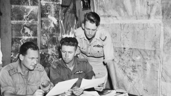 Lyall, right, checking maps of Japanese positions in operational area, Ramu Valley in New Guinea. Picture: Supplied.
